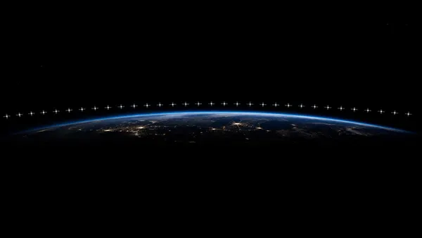 How many satellites does Starlink have? A chain of them strung across the night sky above Earth's curved horizon